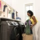 Persona separando ropa para decidir que ropa se puede meter en la secadora antes de poner una colada