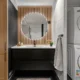 Mueble para lavadora y secadora en torre ikea en una lavandería pequeña con lavadora y secadora apiladas junto a estantes de almacenaje