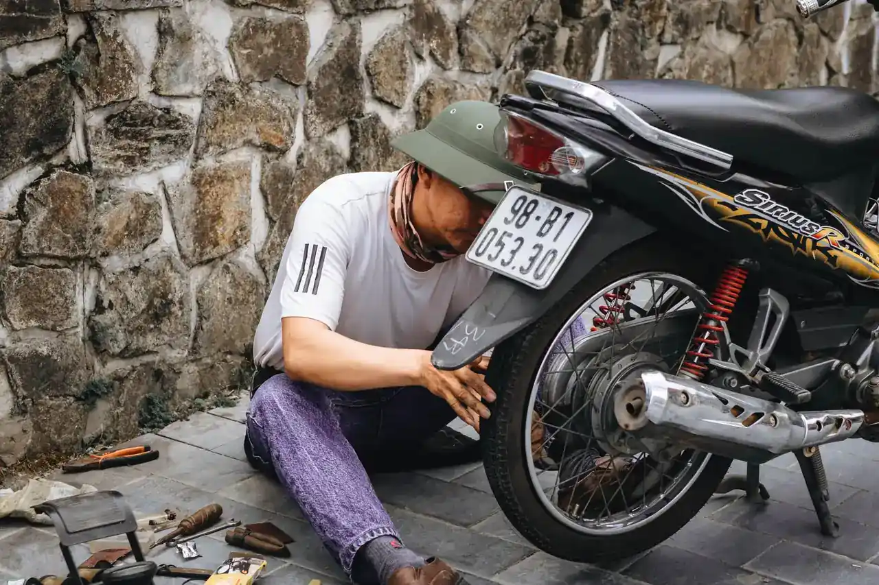 Mecánico desmontando la rueda delantera de un patinete Xiaomi