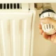 Fotografía de un termostato programable en la pared, ideal para ilustrar ahorrar energía calefacción en el hogar.