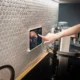 Mano tocando una vitrocerámica táctil para desbloquear vitro teka en la cocina